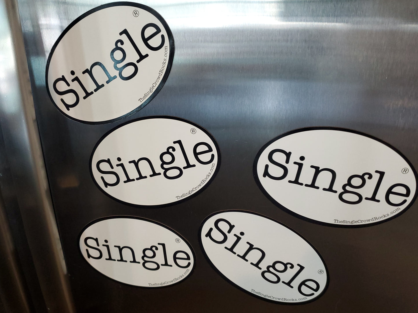 Single® labeled Magnets on a refrigerator.