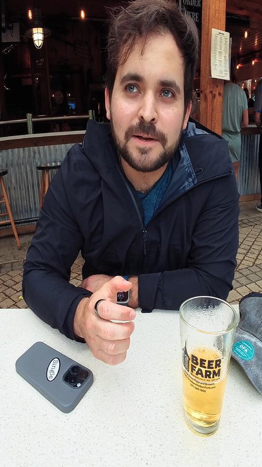 Sebastian with a Single® Small Sticker on his phone while out having a drink.