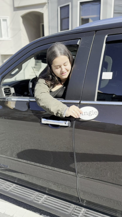 Angelina places a Single® Magnet on her SUV.