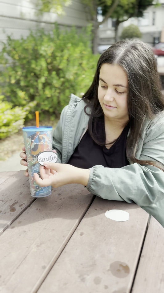 Angelina places a Single® Medium Sticker on her mug.