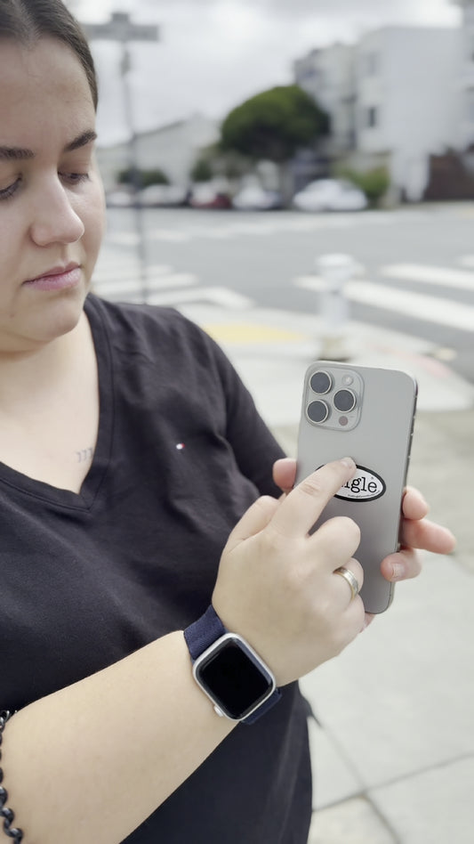 Angelina places a Single® Small Sticker on her phone.