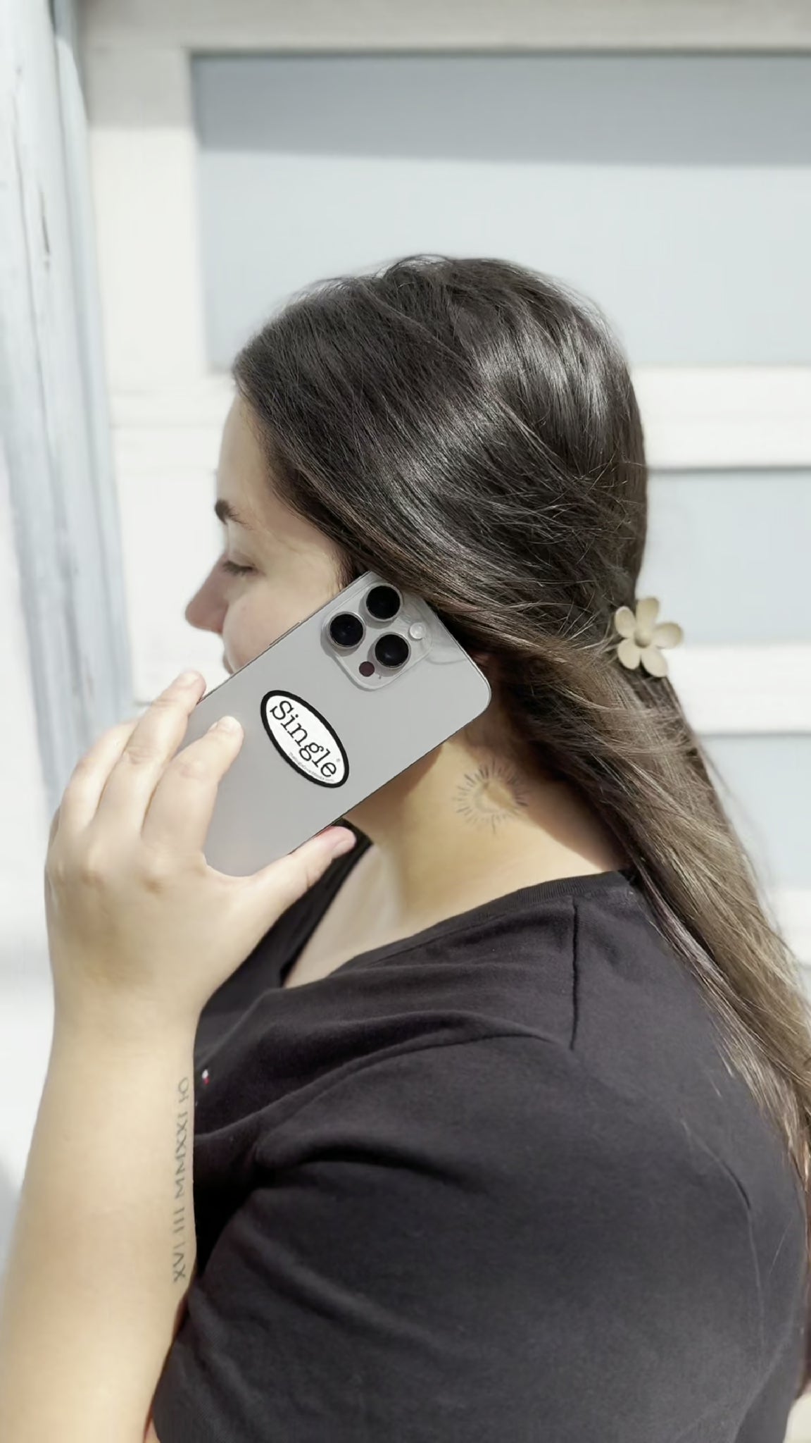 Angelina strolls with a Single® Small Sticker on her phone.