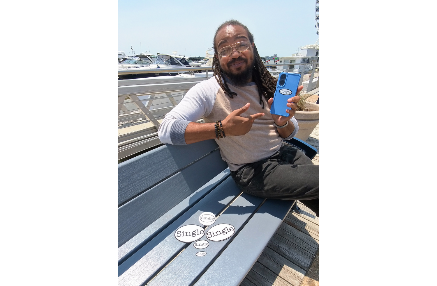 Dwight sits with The Single® Crowd Rock’s Bundle No.3, which includes the Single® Small Sticker on his phone. 