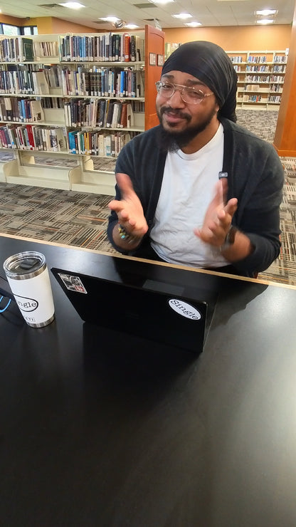Dwight in the library with a Single® Medium Sticker on his tablet, and on his tumbler.