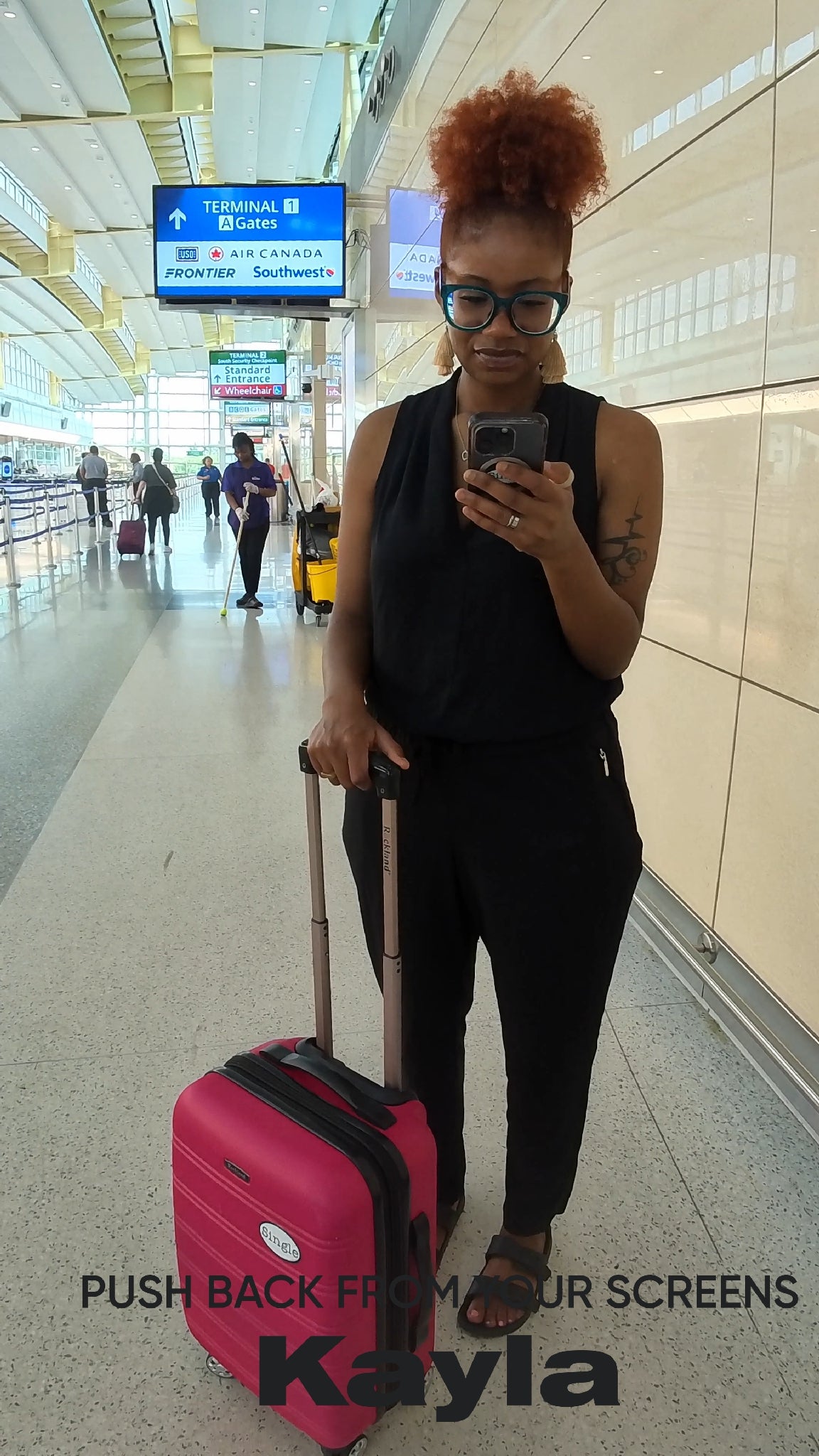 Frequent traveler Kayla strolls through the airport with a Single® Medium Sticker on her luggage.