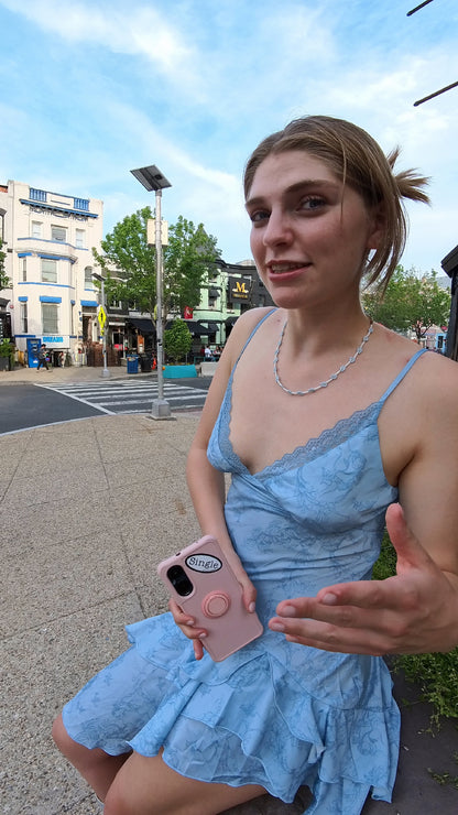Maeve with a Single® Small Sticker on her phone.