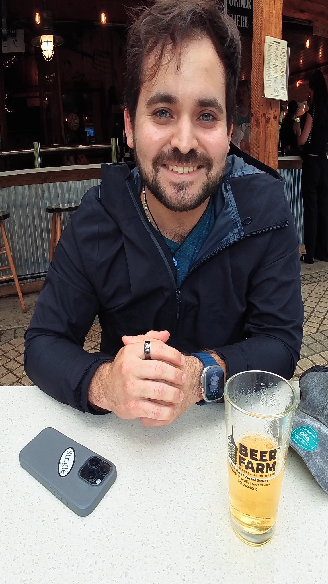 Sebastian with a Single® Small Sticker on his phone while out having a drink.