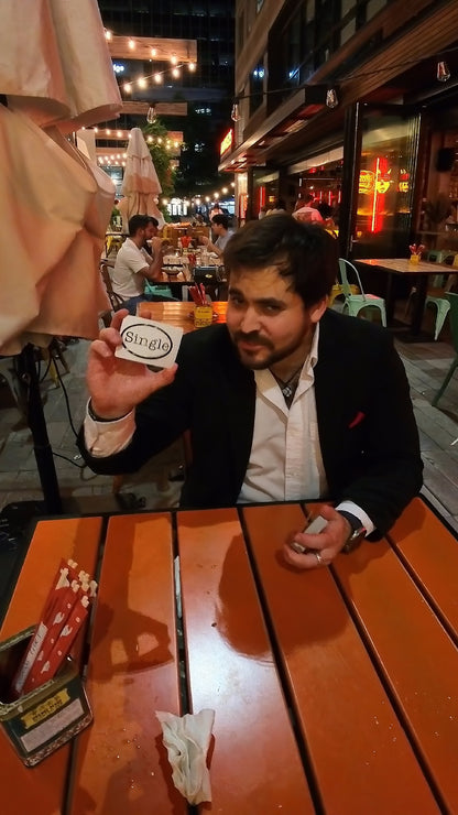 Sebastian uses a Single® Medium Sticker for a card trick while filming his “I am Single” commercial.